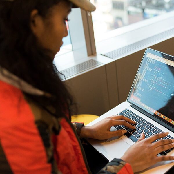 Woman coding on her laptop.