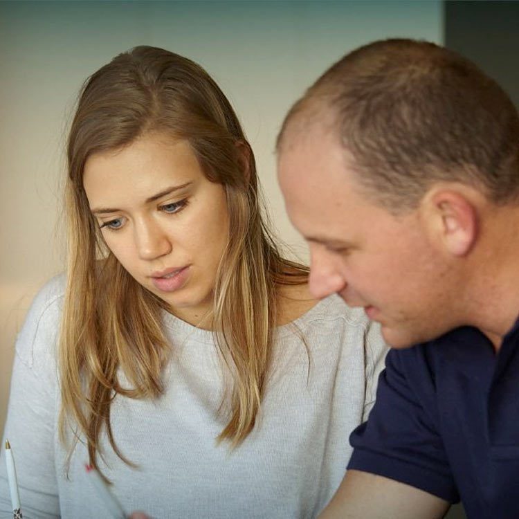 Man and woman staring at a coding problem together.