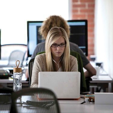 Woman sitting in front of her laptop working.