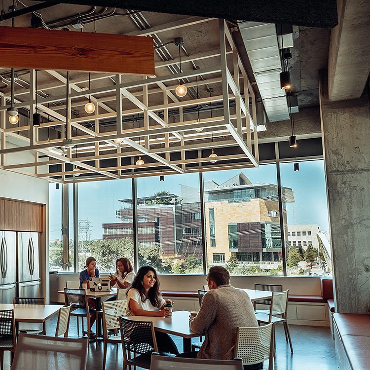 Galvanize students conversing with peers in the campus common area.