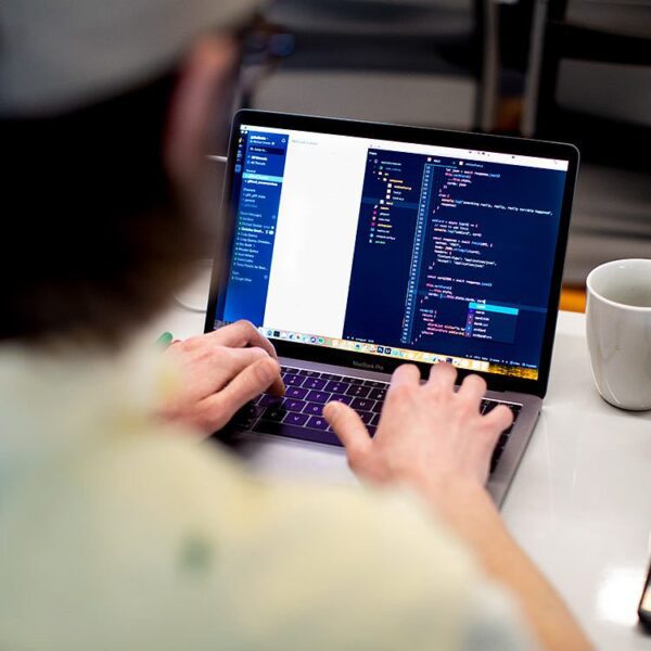 Man programming on his laptop.