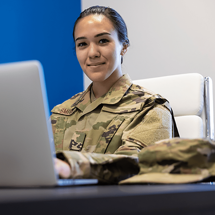 Person in Military uniform working on a computer.