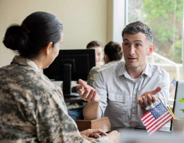 Two people discussing VET TEC program funding options.